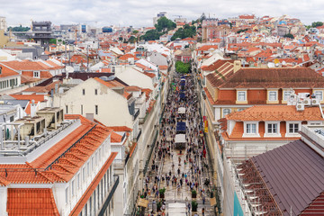 Rua Augusta seen from Arco viewpoint and pedestrian zone with traditional buildings and Santa Justa Lift to the left, Lisbon, Portugal