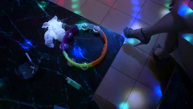 Sex Worker in High Heels with Tambourine and Dirty Ashtray