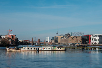 Berlin Skyline from river Spree with ship ruin, Oberbaum Bridge and TV Tower