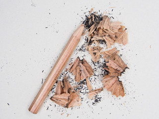 Pencil and debris on grey sketch notepad background