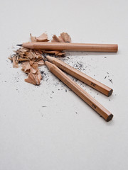 Pencil and debris on grey sketch notepad background
