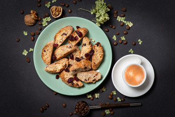 Studio shot of homemade cakes on a  green plate with a cup of  coffee