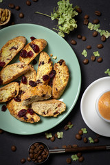 Studio shot of homemade cakes on  a green plate with a  cup of coffee