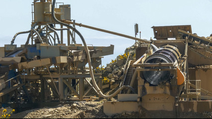 machinery at an open-cut gold mine in new zealand processes alluvial gravel for gold