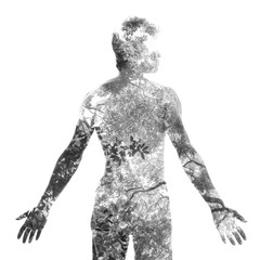 Fototapeta premium Double exposure, of a young shirtless man blended with tree branches shows the perfect beauty of nature's creation and growth, black and white