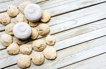 Top view on Meringue, Marshmallow, Zephyr on white rustic wooden background. Flat lay. Pastry concept, copy space. Zephyr.