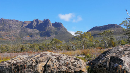 the view of mt ossa rom the overland track with dolerite boulders in the foreground