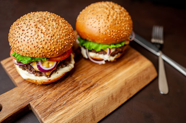 Two Delicious Fresh Homemade Burger on a Cutting Board