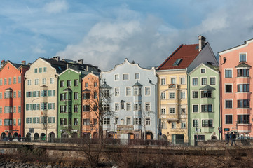 Obraz premium INNSBRUCK, AUSTRIA - JANUARY, 01 2019: Panoramic view of the historic city center of Innsbruck with colorful houses along Inn river and famous Austrian mountain in the background - Tyrol, Austria