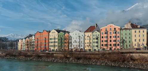 INNSBRUCK, AUSTRIA - JANUARY, 01 2019: Panoramic view of the historic city center of Innsbruck with colorful houses along Inn river and famous Austrian mountain in the background - Tyrol, Austria