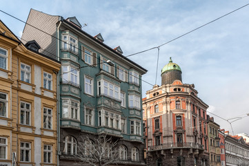 Fototapeta premium INNSBRUCK, AUSTRIA - JANUARY, 01 2019: The ornate and colourful buildings in the famous Maria Theresien Strasse in the old city center of Innsbruck, the Austrian Alpine town - Austria
