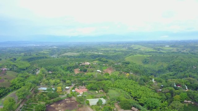 AERIAL: high and straight push over the precious Panaca park in Quidio, Colombia, that's been surrounded by coffee plantations.