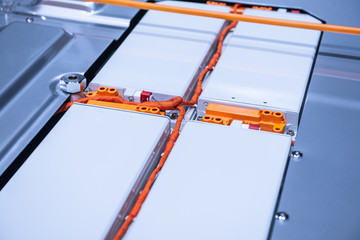EV car battery pack. Electric car lithium battery pack. Blue toned. Car maintenance.