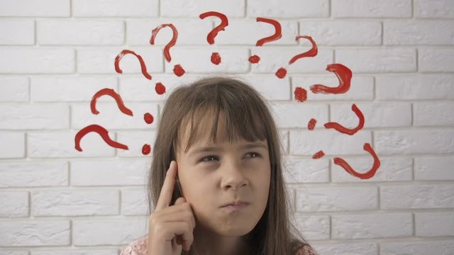 Questions in the head of a child. A little girl with questions in her head.