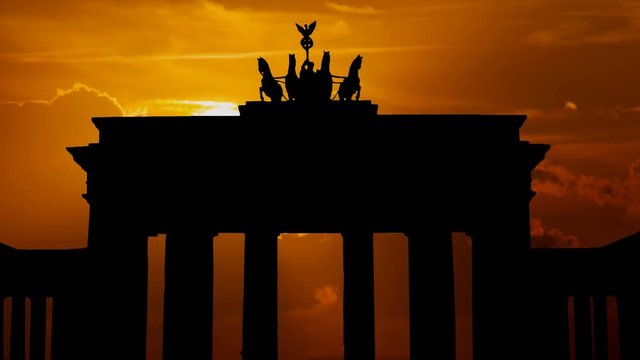 Brandenburg Gate, icon of Berlin and Germany at sunset, with Red Sun and Clouds, Germany, Europe