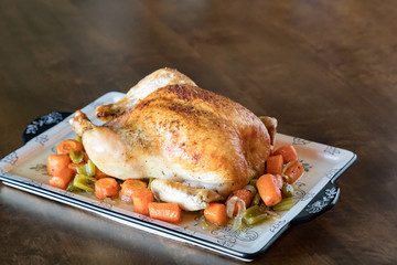Roasted Chicken with Vegetables on a wooden table background