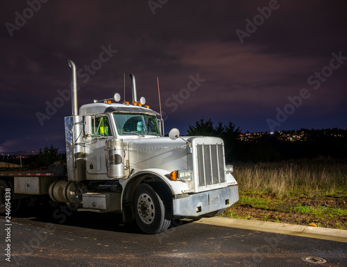 Old Big Rig Day Cab Semi Truck With Flat Bed Semi Trailer Stand On