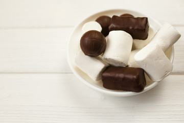 top view of various chocolate pralines isolated on white background