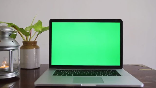 A laptop with a green screen which can be removed to place any content as per the requirement.