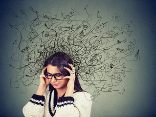 Thoughtful stressed young woman in glasses with a mess in her head - obrazy, fototapety, plakaty