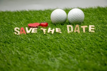 Golf Save the date with golf ball and heart on green with love