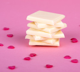 Stack of white chocolate with small hearts made with ruby chocolate on Valentines Day