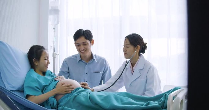 Doctor use stethoscope to examine pregnancy woman.
