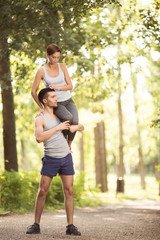 Young couple doing exercises outdoors