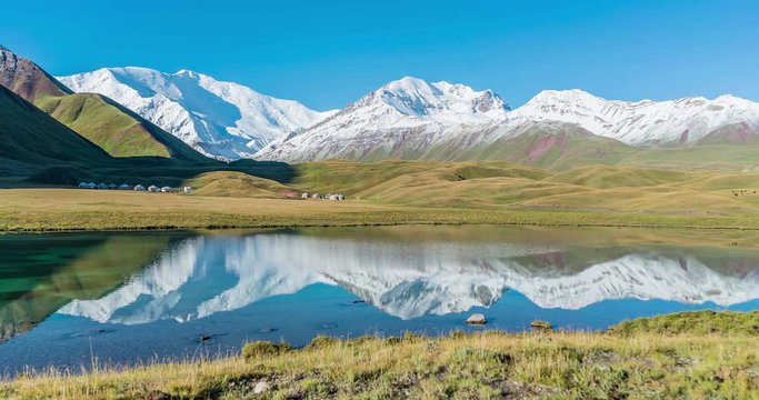 Time lapse video of panoramic view of Lenin Peak at sunrise from Tulpar Kol lake - Kyrgyz Pamir Mountains - Kyrgyzstan and Tajikistan border- Central Asia called "Roof of the World"
