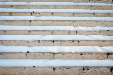 Old rusty  marble  stairs covered with snow 