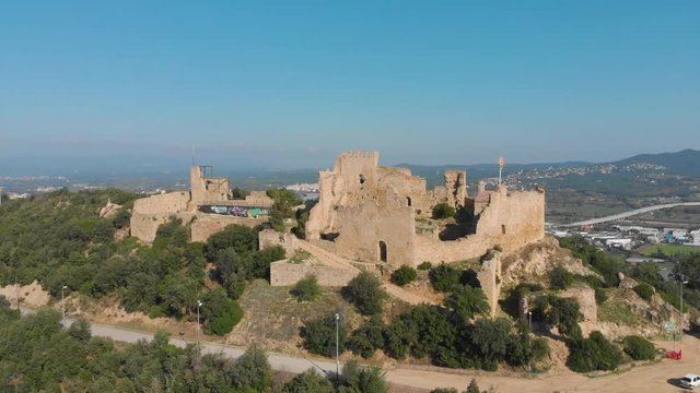 Landscape of the ruins of Palafolls Castle on the top of the hill on a beautiful sunny day. Catalonia Spain. Aerial view travelling