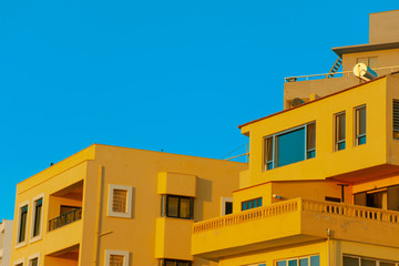 Fototapeta na wymiar Yellow houses on a coast of Rhodes Island, Greece