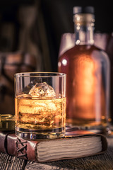 Tasty whisky with ice and golden bottle