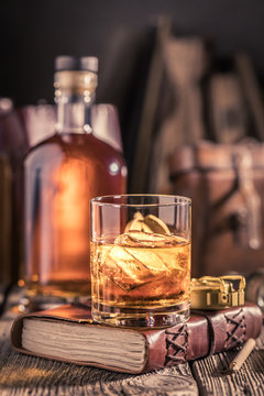 Glass Of Whisky With Ice And Golden Bottle