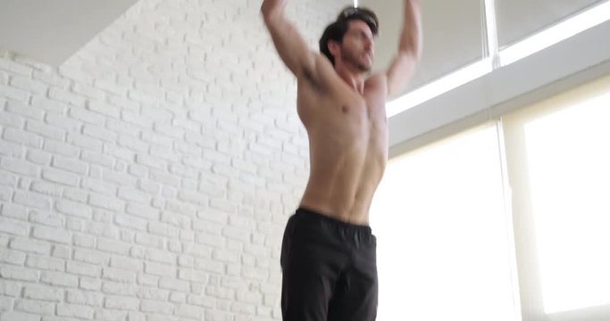 Beautiful young white man training at home. Strong caucasian male athlete exercising for wellness, weight loss, fitness, healthy life in domestic gym. Latin people and sports