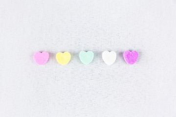 Conversation Hearts Line Up On A White Background