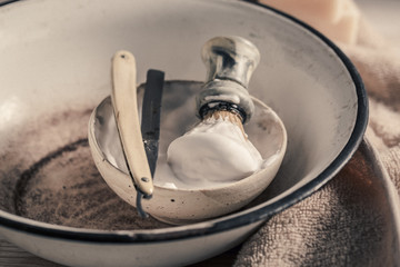 Vintage barber equipment with old razor, soap and brush