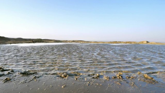 The view from the shoreline with mud exploding out of the ground at the Mud Volcanoes in Baku, Azerbaijan