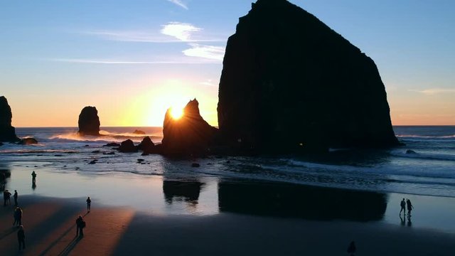 Drone footage slowly rising to reveal an amazing sunset in Cannon Beach on the Oregon coast.