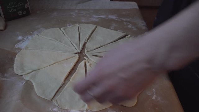 Girl cooking homemade pastery and lining it on a tray for Christmas.