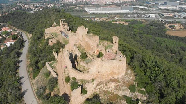 Beautiful view of the hill with the ruins of Palafolls Castle on a sunny day. Catalonia Spain. Aerial view travelling