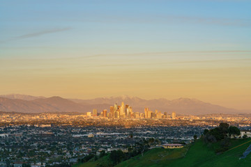 Fototapeta premium Sunset aerial view of the beautiful Los Angeles downtown cityscape with mt. Baldy