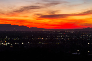 Dramatic predawn view of San Fernando Valley neighborhoods and the San Gabriel Mountains in the city of Los Angeles, California.  