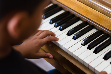 Fototapeta premium Young child playing the piano