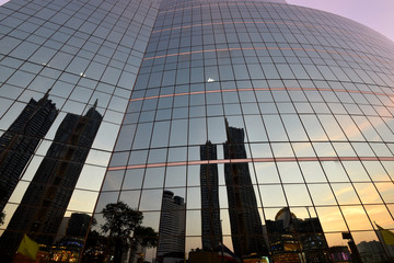 Building reflection from another building glass window in sunset time
