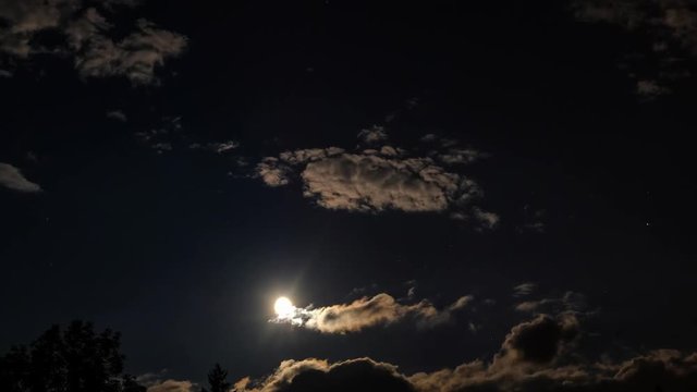 Clouds moving on moon in the dark sky. Timelapse video