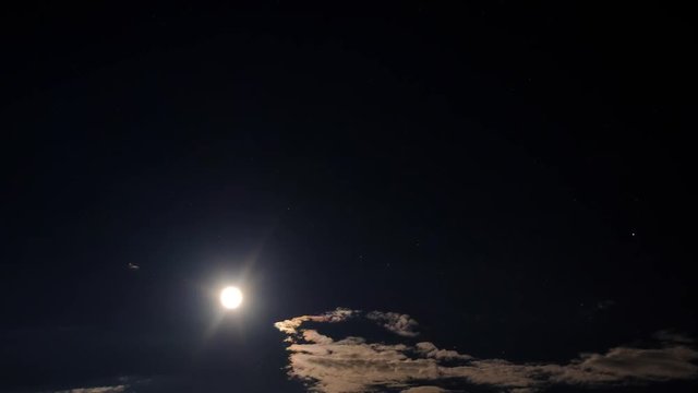 Clouds moving on moon in the dark sky. Timelapse video