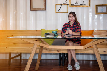 Hipster women with a coffee cup working in a coffee shop