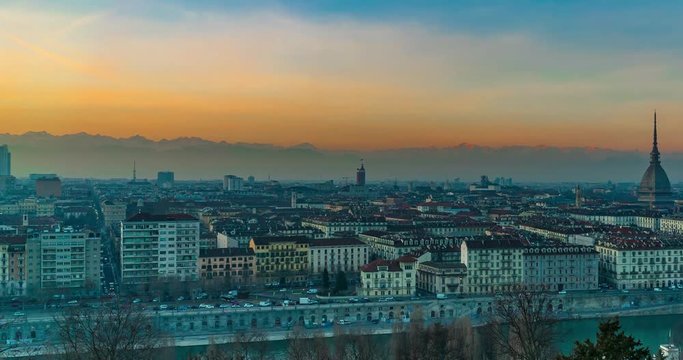 Turin time lapse video, Torino city time lapse panoramic cityscape fading from day light to night. Mole Antonelliana with Torino panorama and mountain alps in background