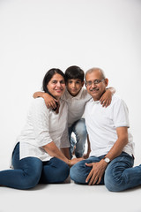 Indian/asian senior couple with grandson, isolated over white